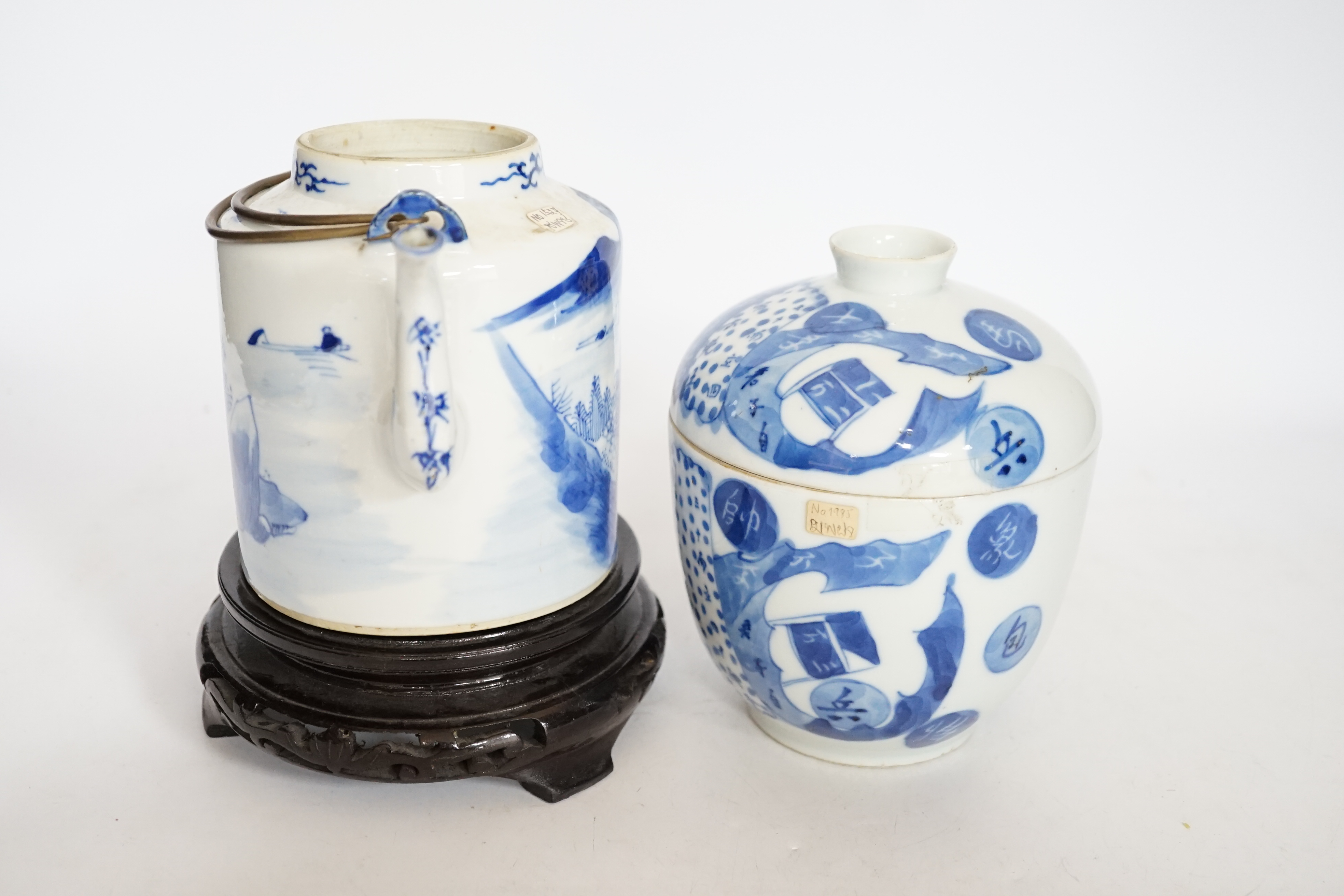 A Chinese Straits blue and white jar and cover, 19th century, a cylindrical teapot and an associated hardwood stand, largest 15cm high